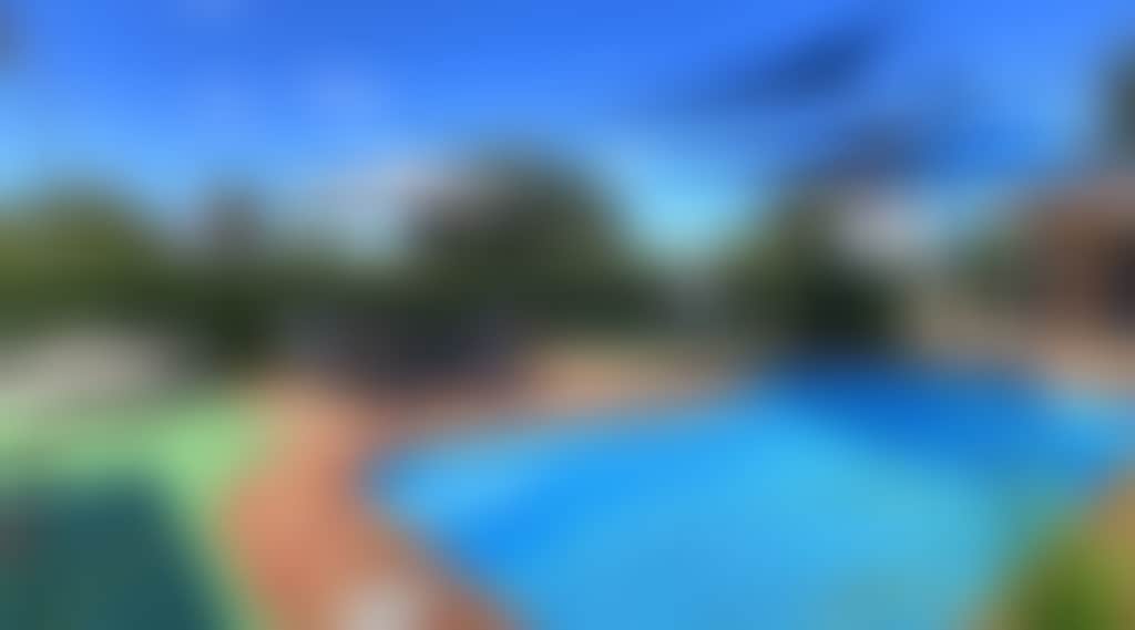 Blue pool with shaded lounge area