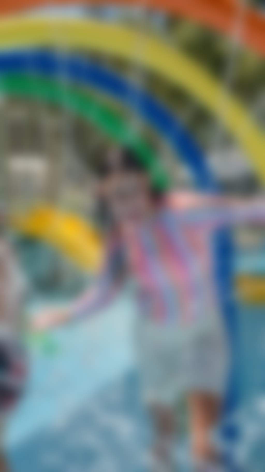 Girl having fun playing at the colourful splash park