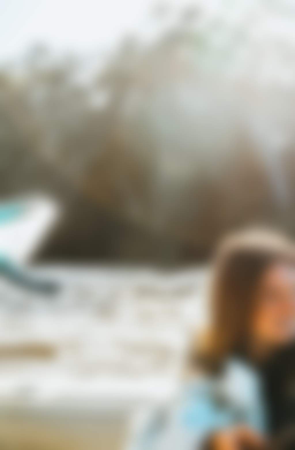 Resized Young woman sitting in a boat with a surfboard on the Murray River