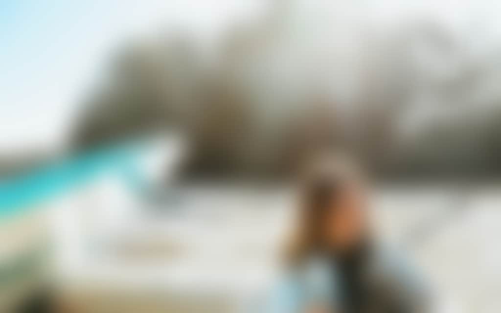 Resized Young woman sitting in a boat with a surfboard on the Murray River
