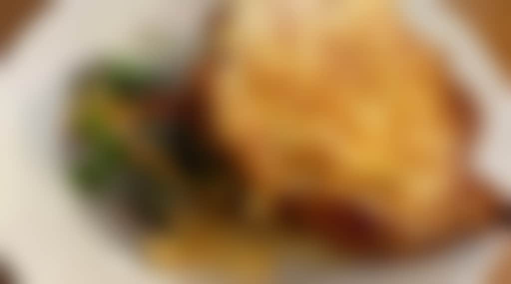 A delicious chicken parmigiana dish with crispy melted cheese