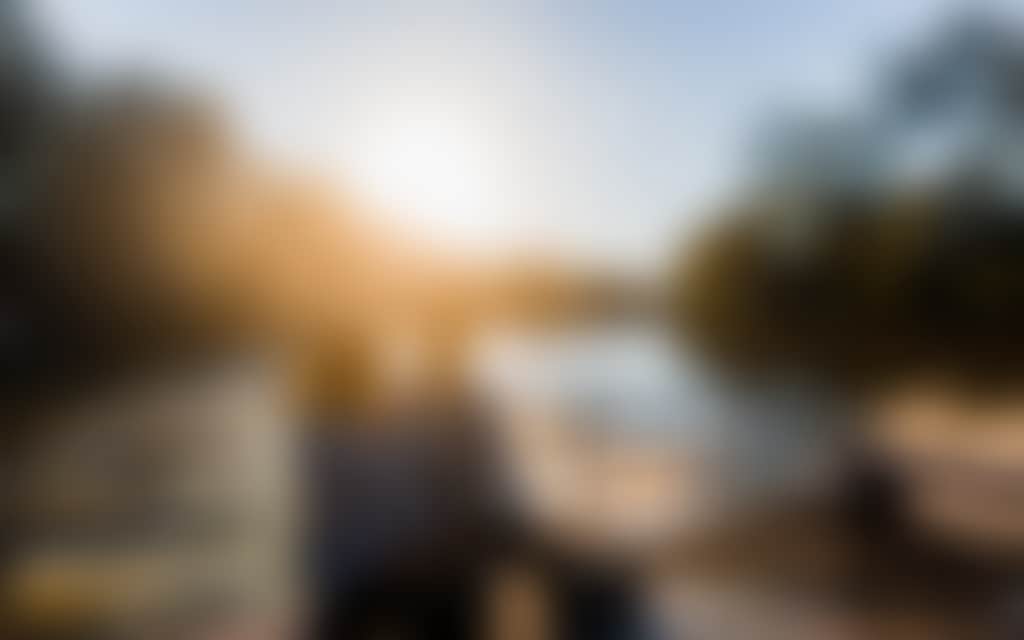 Brunette couple sitting on a historic paddlesteamer with the sunset