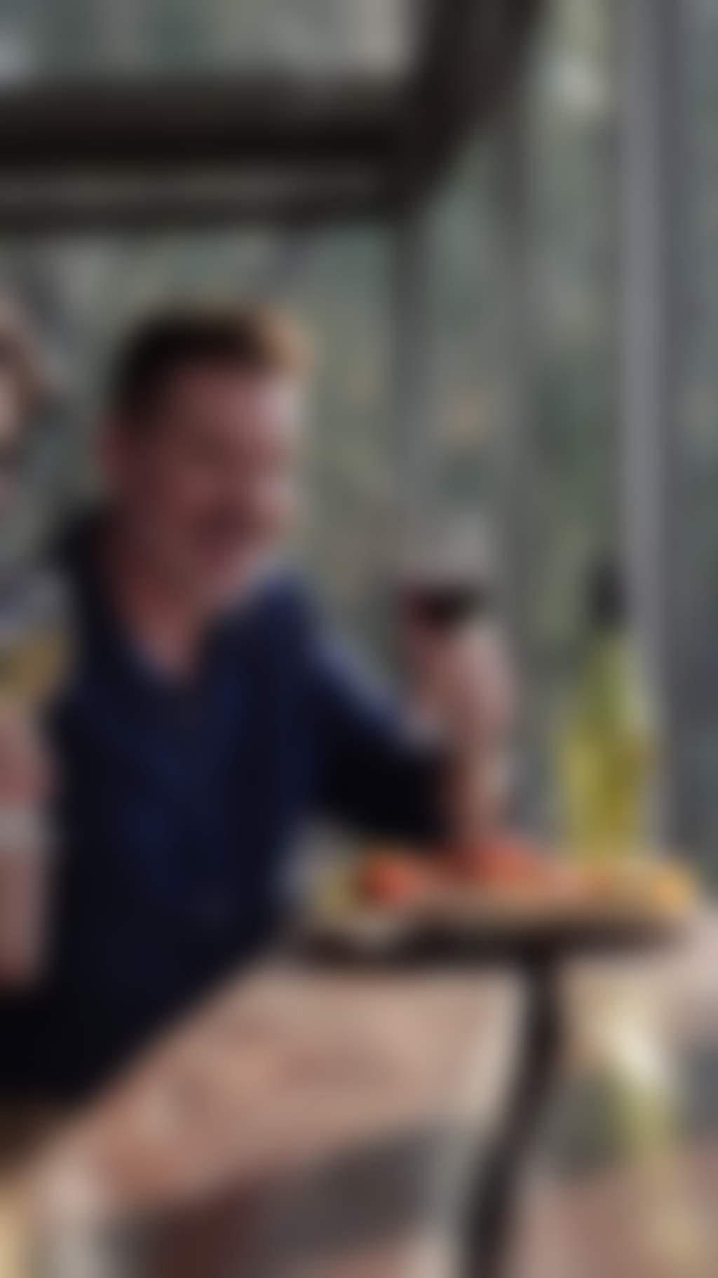 Resized mature couple drinking wine and eating cheese at a winery
