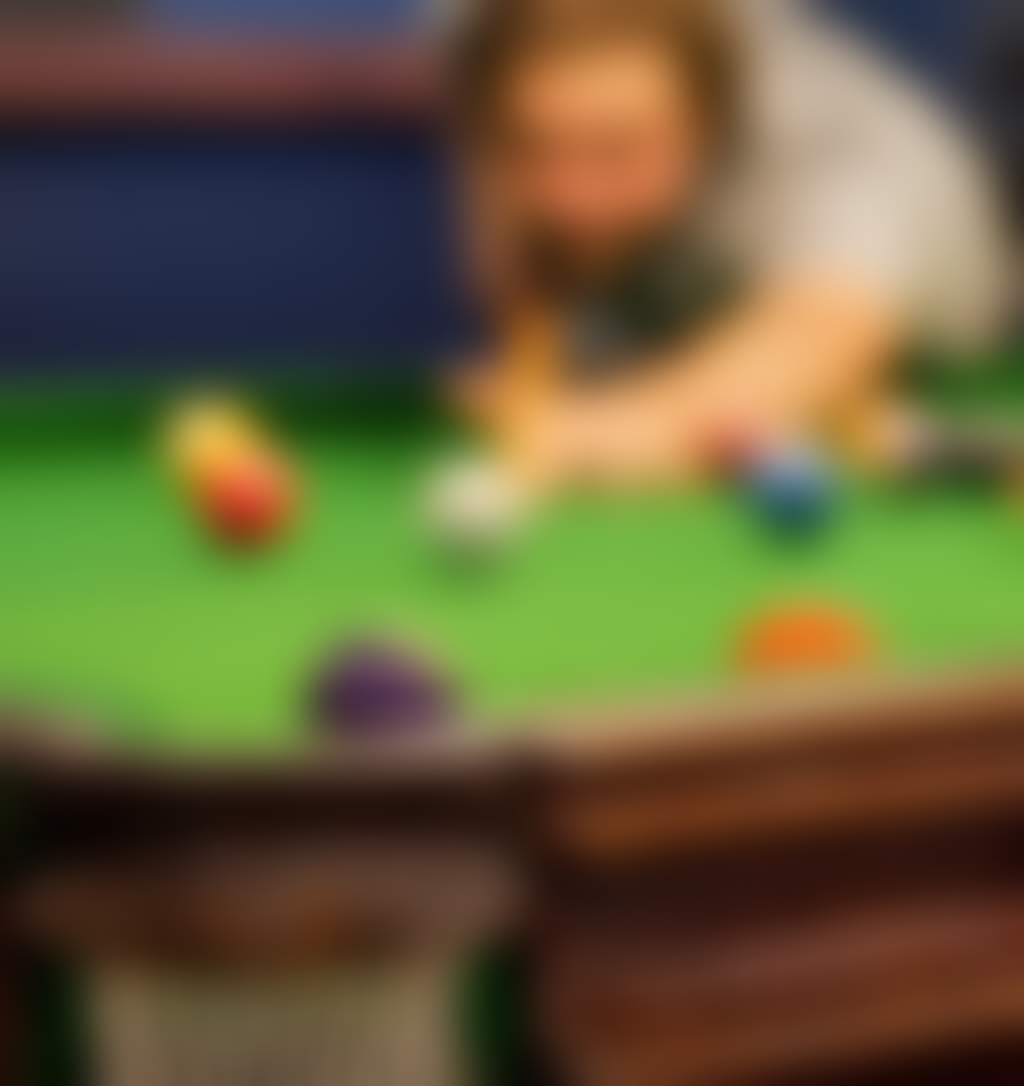 A close up of a man playing pool