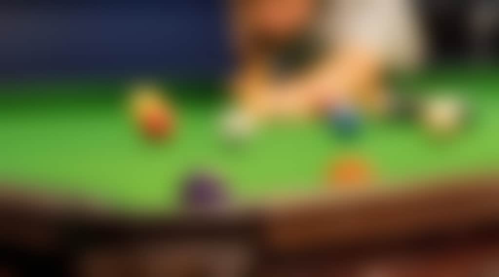 A close up of a man playing pool
