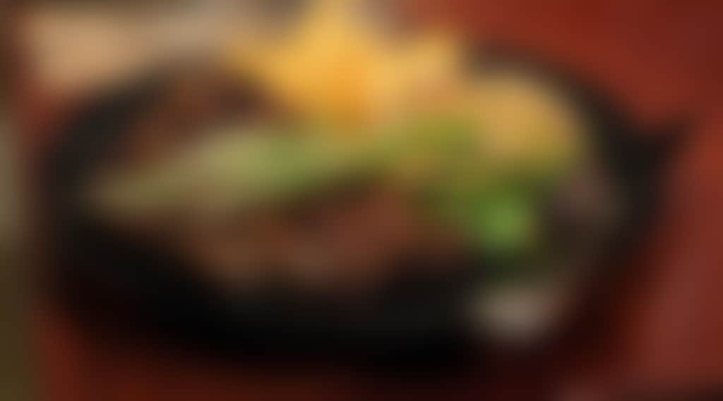 A big steak on a plate served with chips and salad