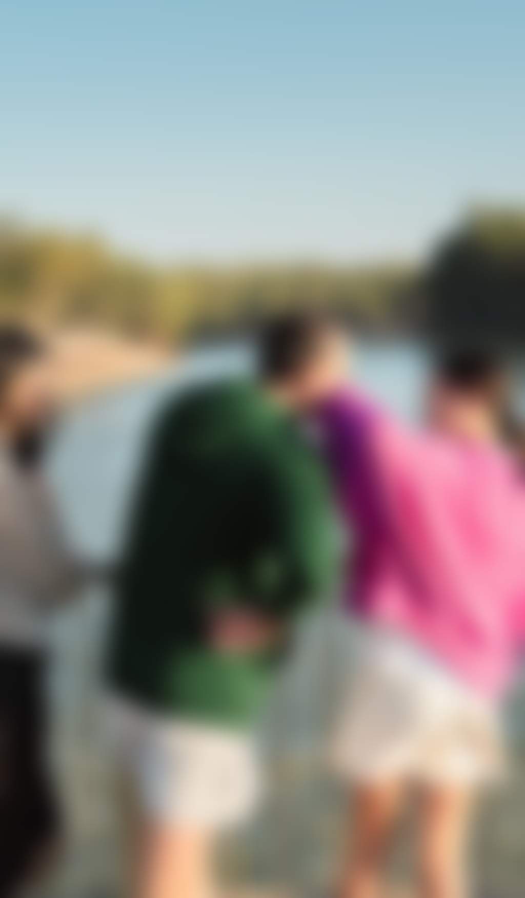 Family walking along a boardwalk and gazing out to the river