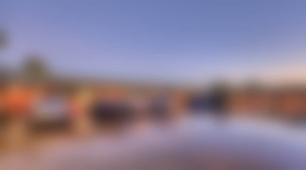 View of motel at dusk with ample parking