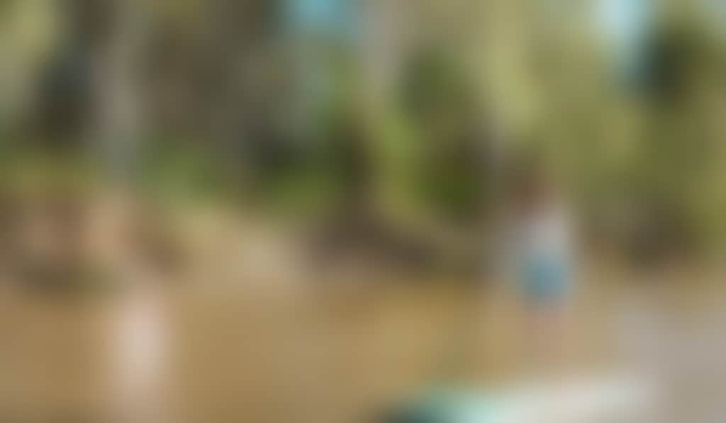 Young woman paddleboarding along the Murray River in Echuca Moama
