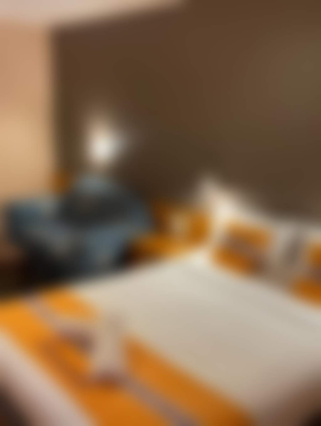 Spacious queen bedroom with couch and yellow linen
