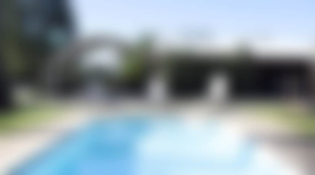 Large gated swimming pool with lounges
