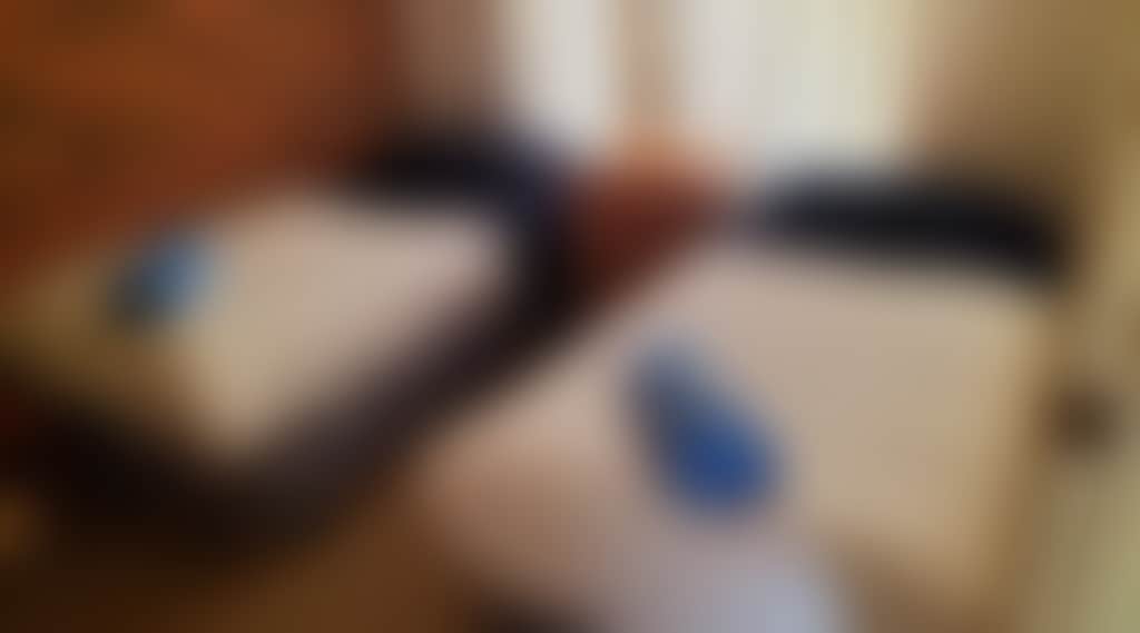 Room with 2 single beds and blue towels