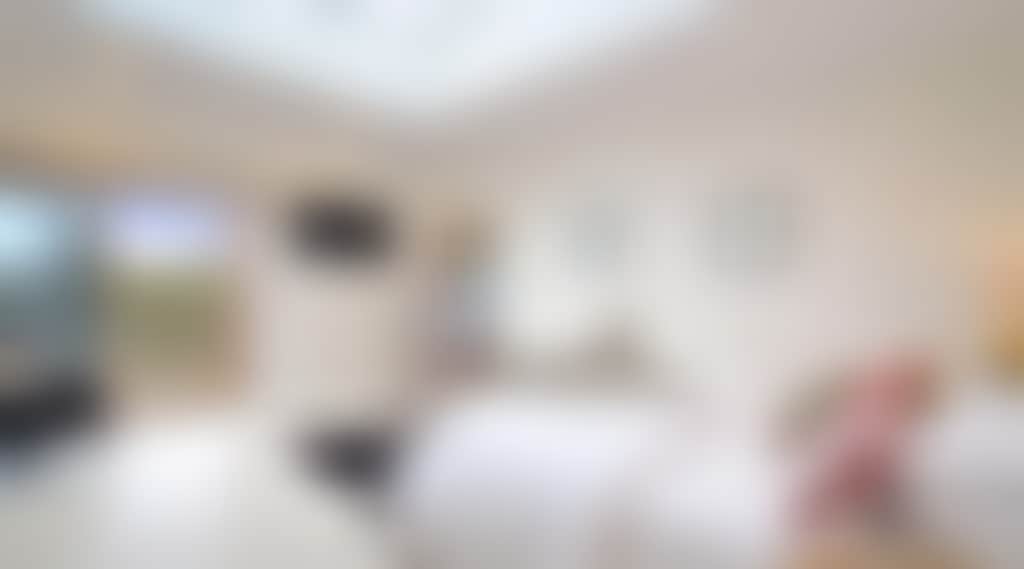 Master bedroom full of light and featuring a balcony and ensuite